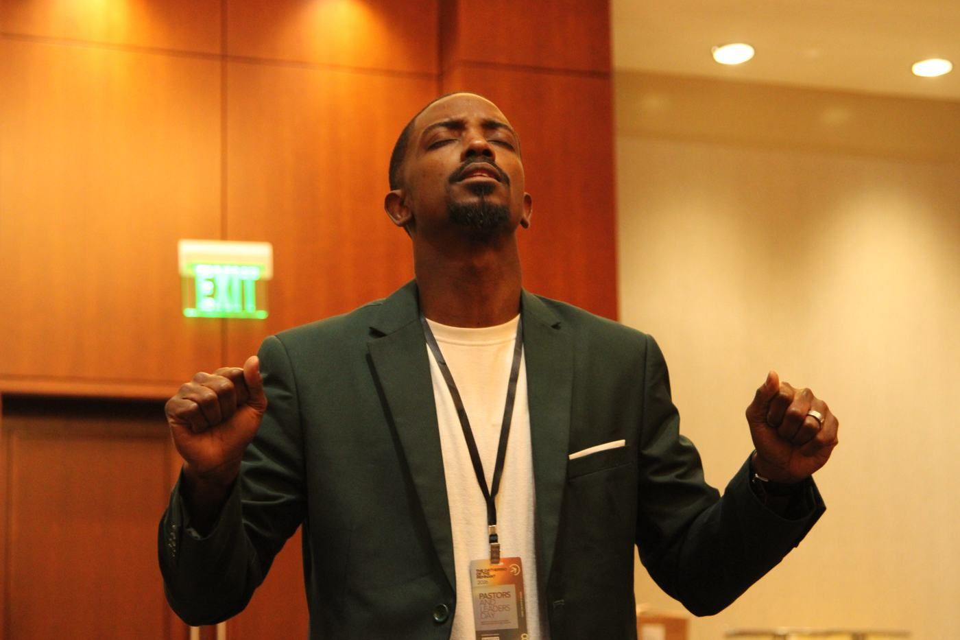 A leader with hands lifted in prayer